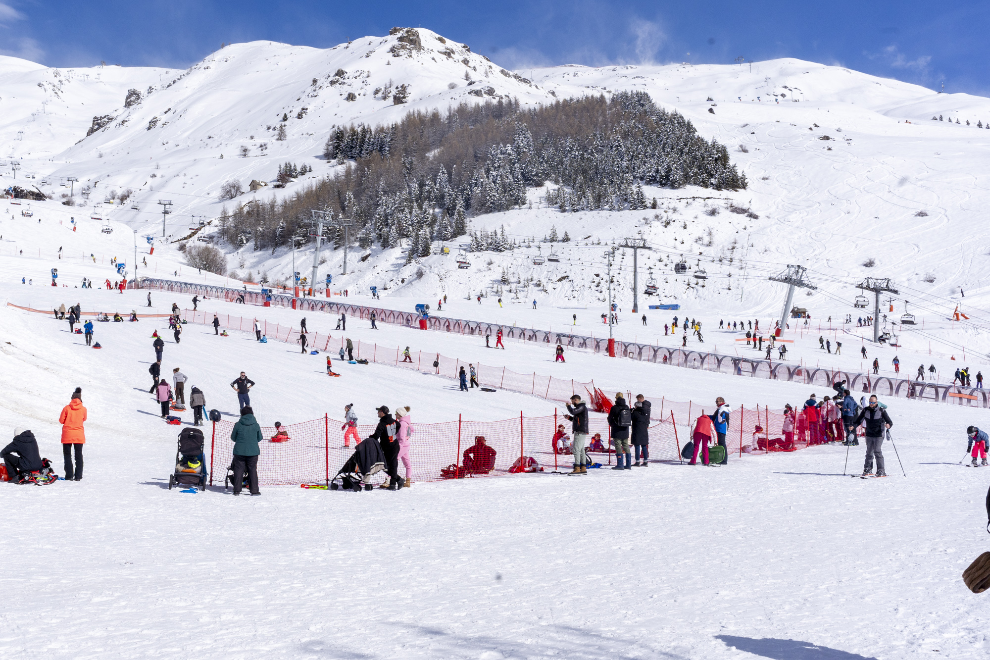 Busy ski resort with families and skiers