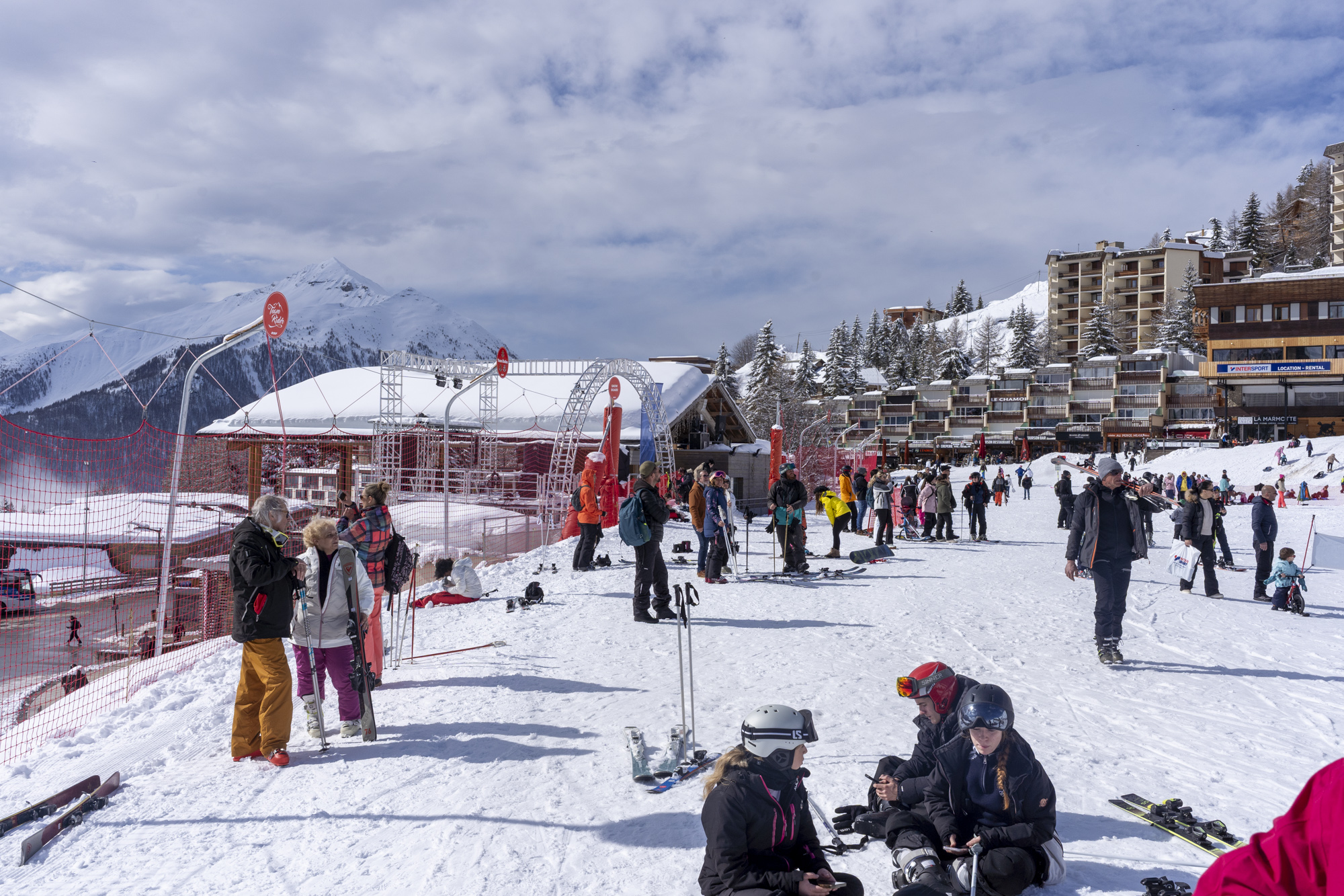 Skiers gathered at the bottom of the snowy slopes